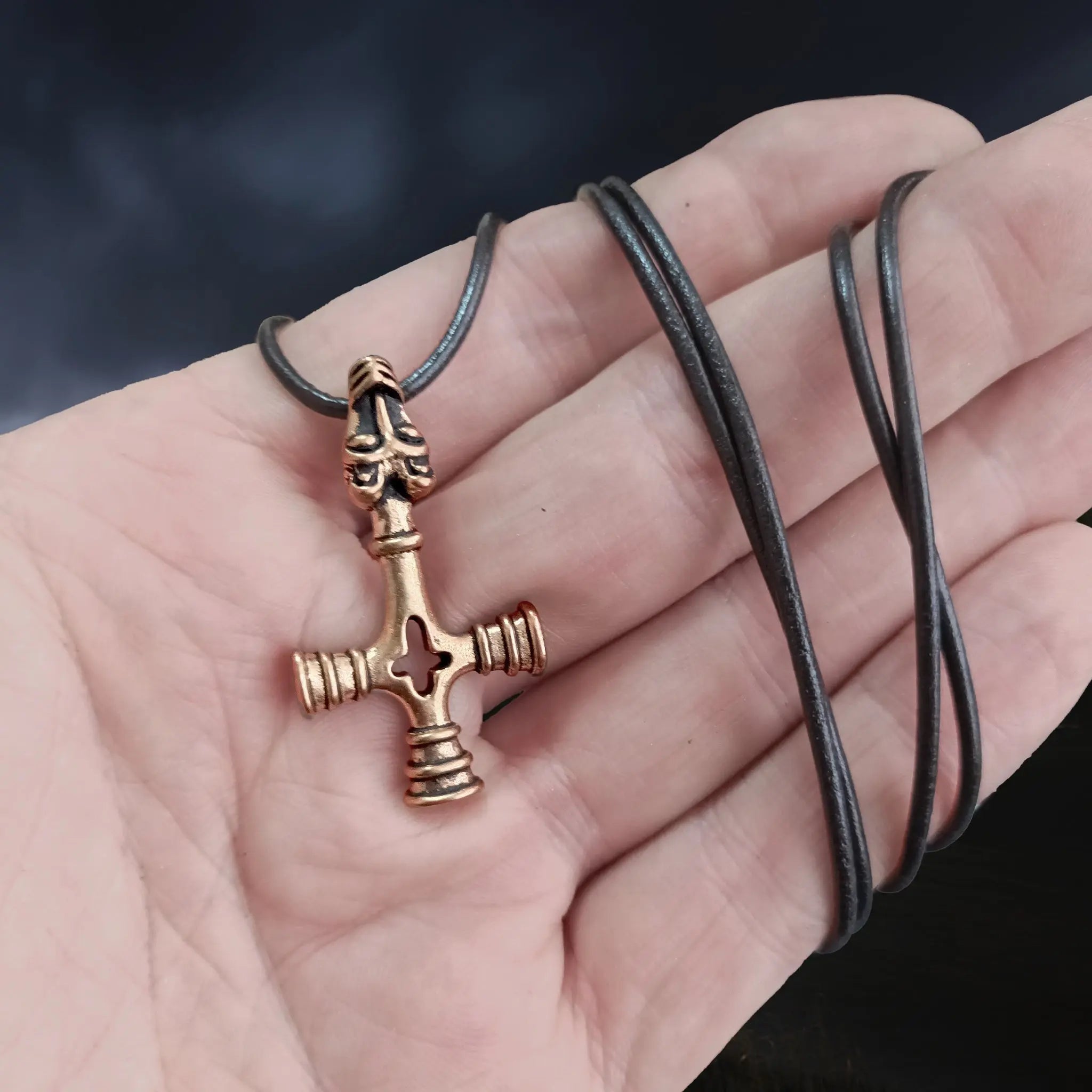 Bronze Wolf Cross Thors Hammer Pendant on Hand with Black Leather Cord