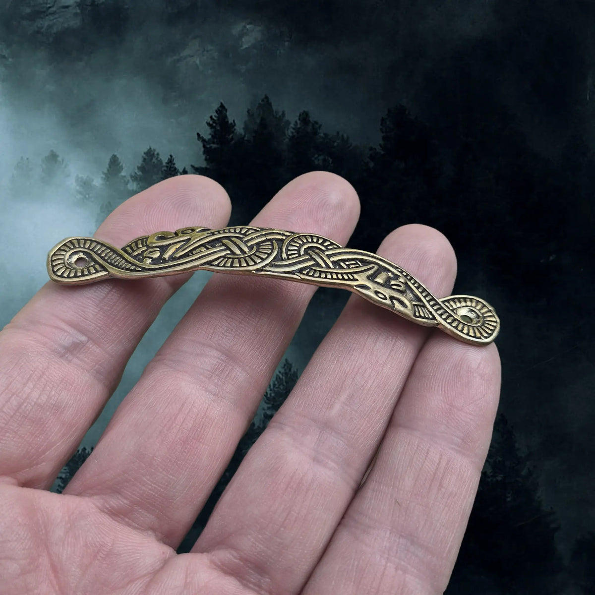 Viking Style Bronze Scabbard Bridge Mount with Serpent Design on Hand - Side Angle View