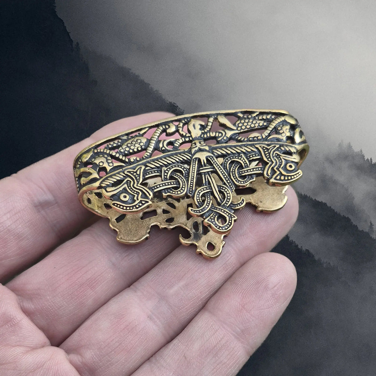Viking Age Bronze Replica Viking Scabbard Mouth from Dybek, Skåne, Sweden on Hand - Angle View