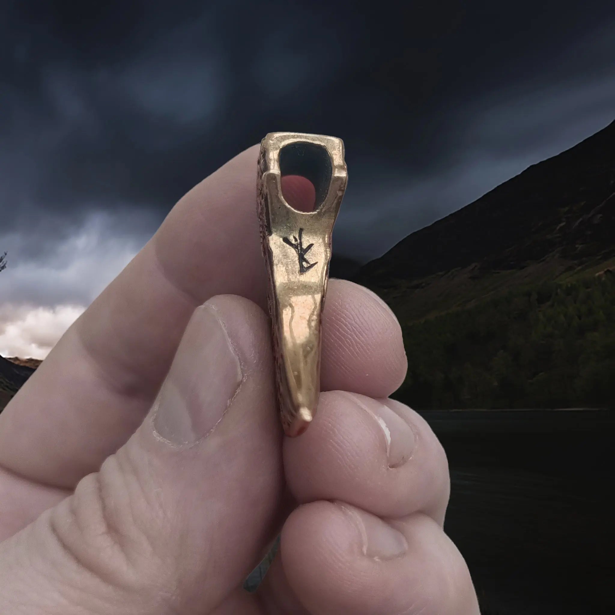 Bronze Knotwork Axe Head Pendant in Hand - Underside View