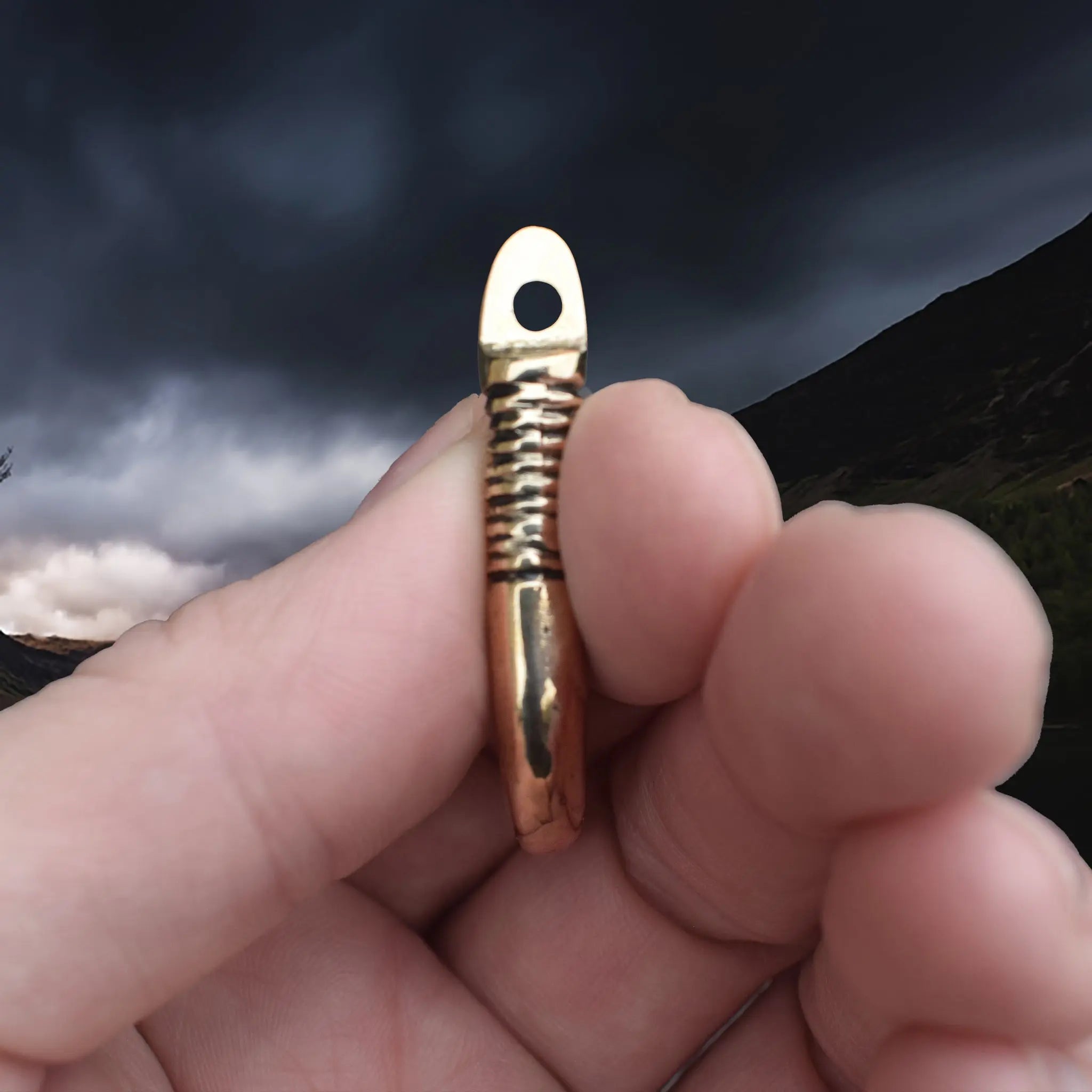 Solid Bronze Replica Viking Bear Tooth Pendant from 9th to 11th century Finland in Fingers - Side View