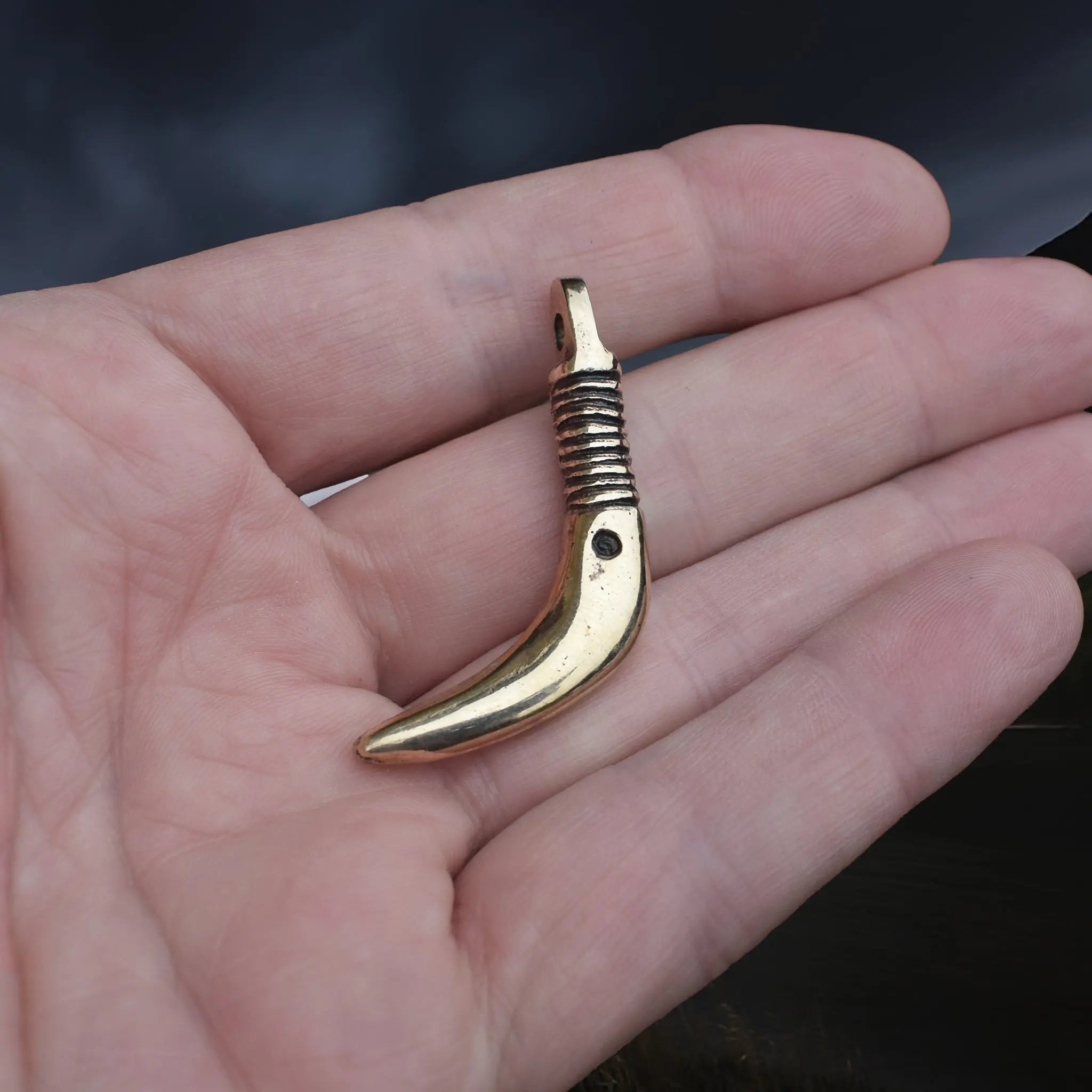 Solid Bronze Replica Viking Bear Tooth Pendant from 9th to 11th century Finland  on Hand