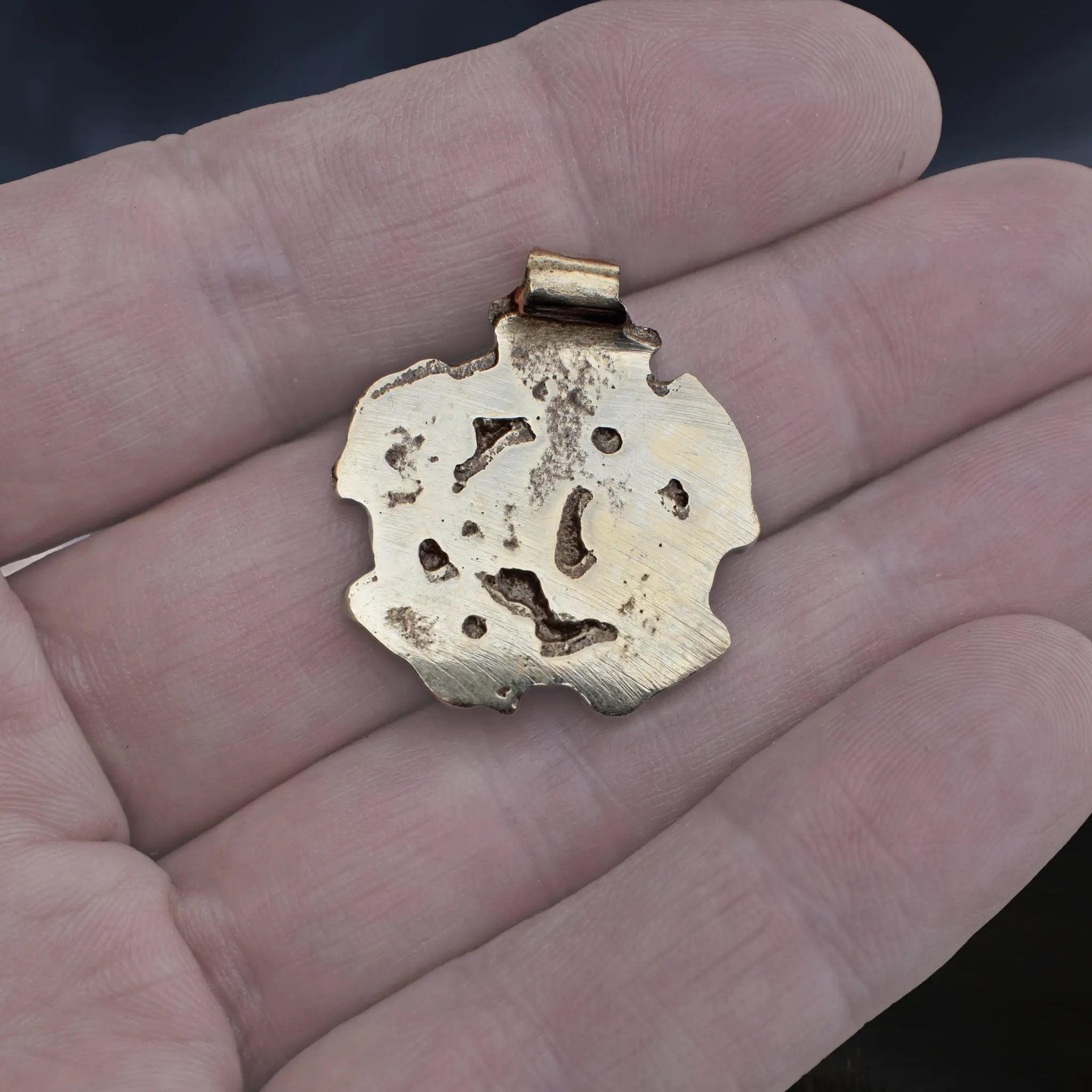 Solid Bronze Replica Viking Gripping Beats Pendant from&nbsp; 10th century Sweden on Hand - Back View