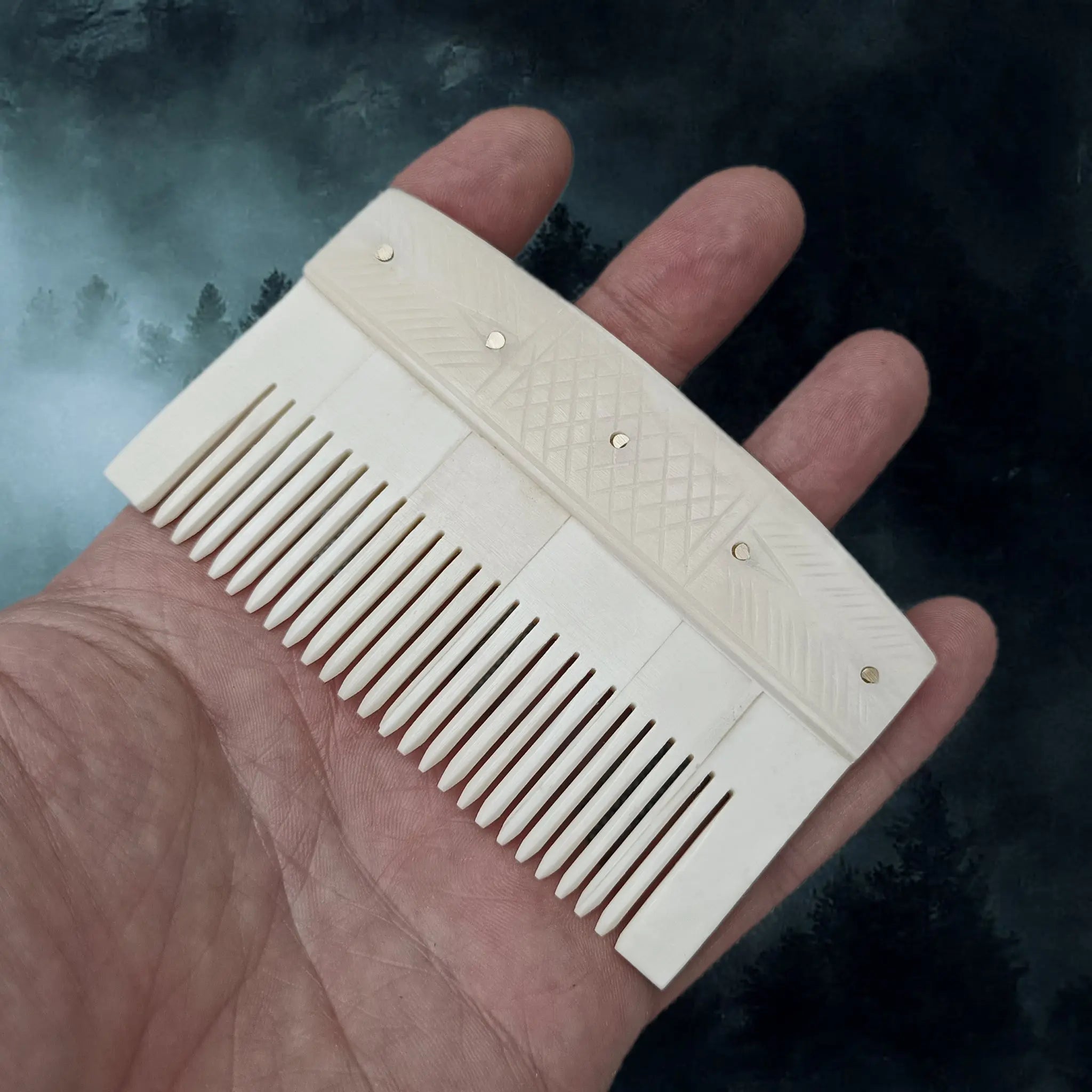 Decorated Bone Viking Comb with Rivets in Hand