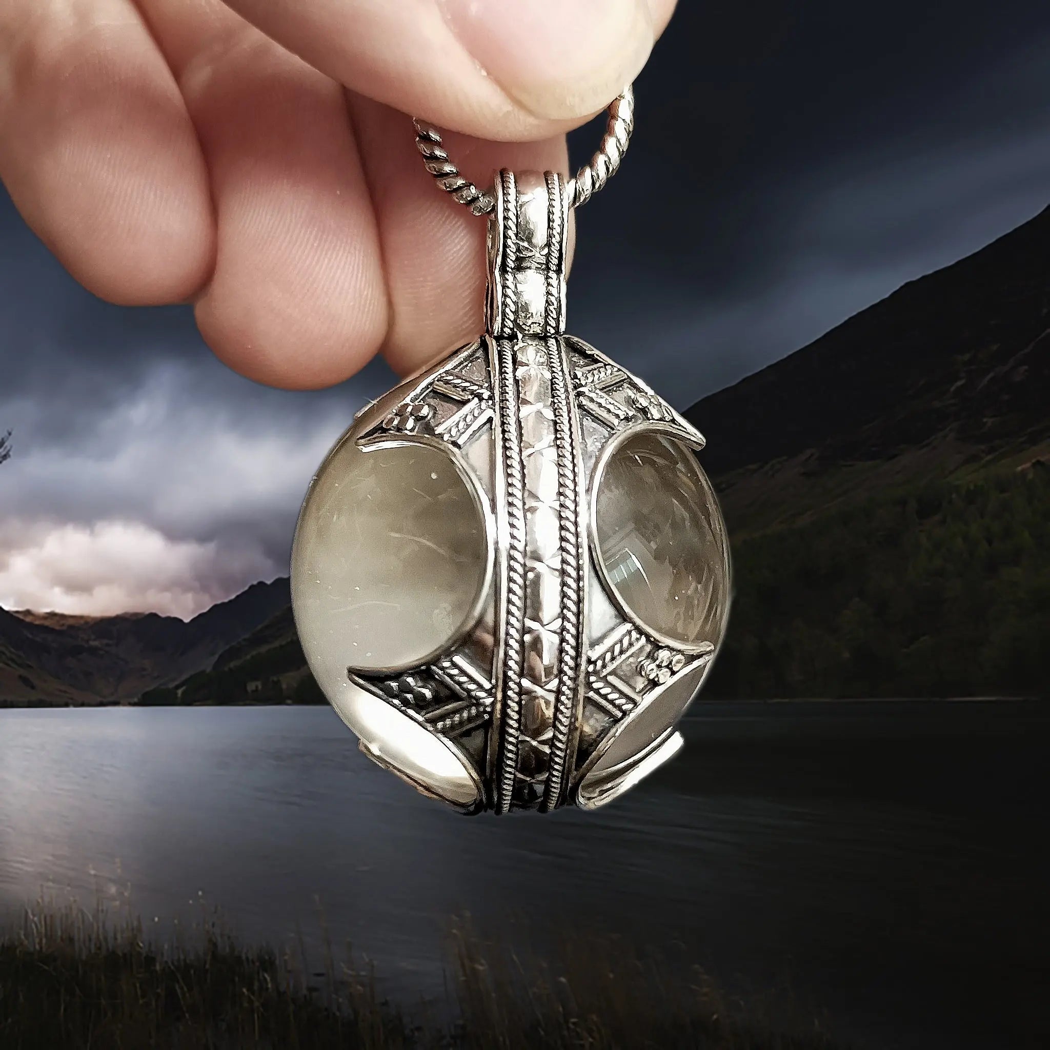 Large Silver Gotland Crystal Ball Pendant in Fingers - Side View