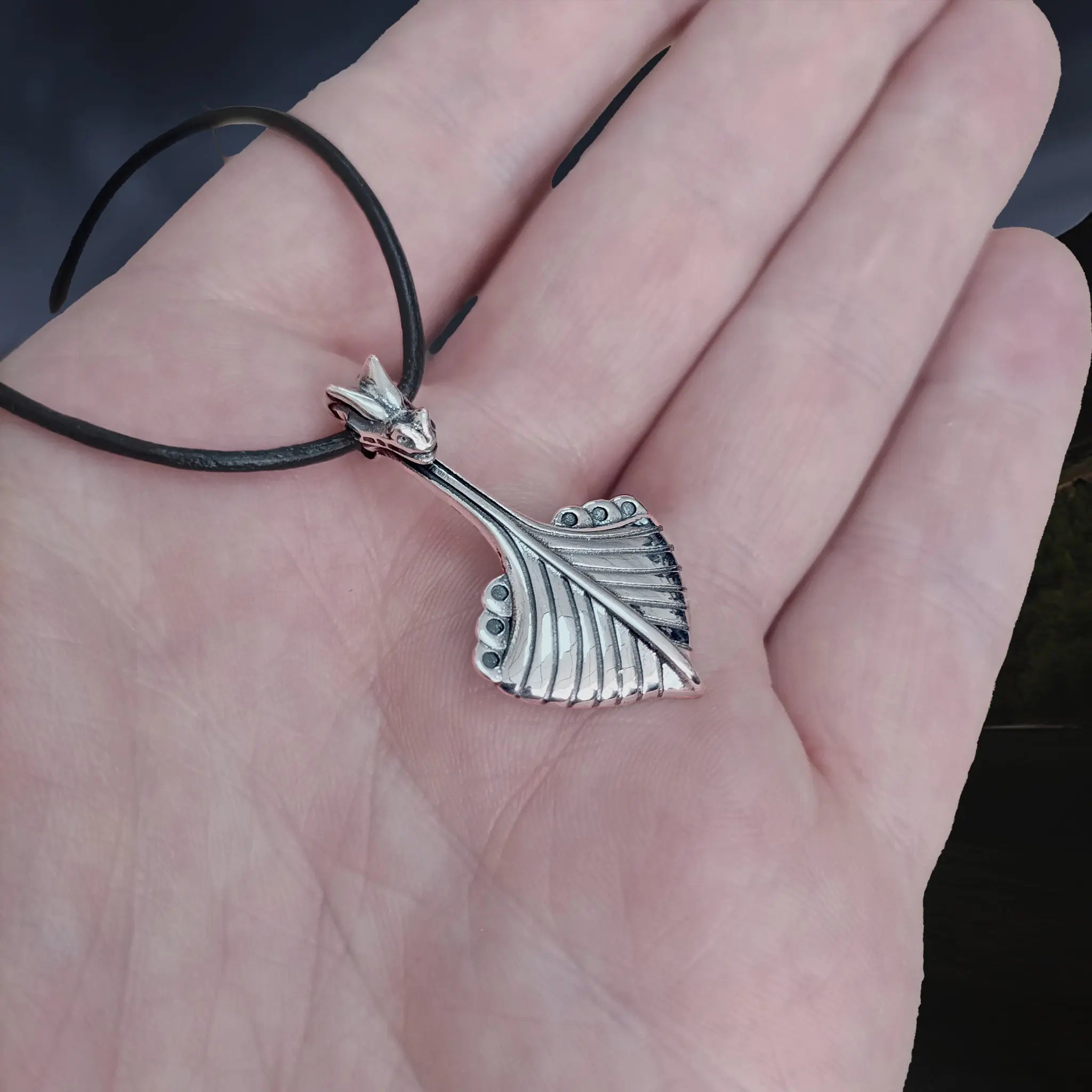 Replica Norwegian Viking Ship Pendant in Sterling Silver on Leather Cord on Hand - Side Angle View