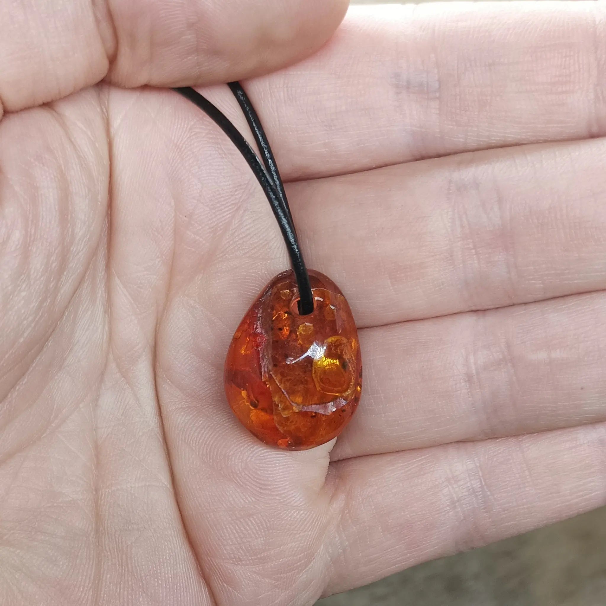 Amber Amulet Pendant on Hand with Leather Thong - Other Shape