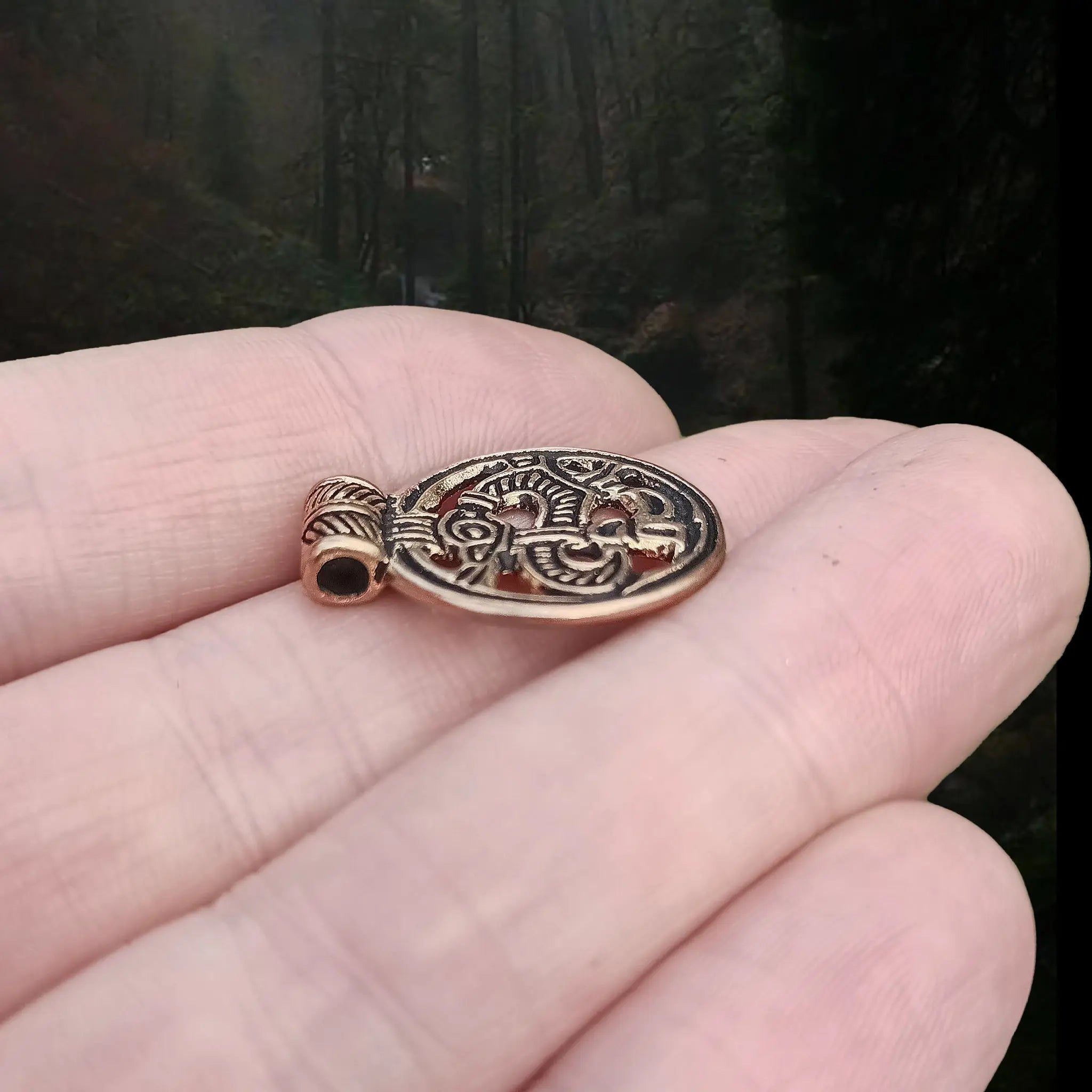 Round Bronze Viking Dragon Pendant from Birka  on Hand - Side Angle View